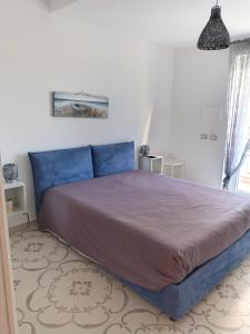 a bedroom with a large bed in a room at LA CAVA DI DAFNE in Bacoli