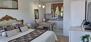 a bedroom with a large bed and a kitchen at Beautiful sea view 6 luxury studio Danijela in Senj