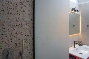 a bathroom with a sink and a mirror at Arodou Studio and Apartment in Mikonos +31 photos
