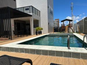 a swimming pool on top of a building at Apto 02 Quartos Mobiliado na Praia do Poço - CABEDELO in Cabedelo