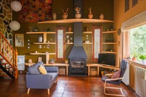 a living room with a couch and a fireplace at La Kolina Casa Rural in Xerta