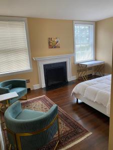 a bedroom with a bed and a fireplace at walnutwood in Owings Mills +42 photos