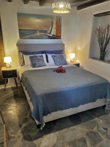 a bedroom with a large bed with a painting on the wall at Our Beautiful House in Ornos, Mykonos in Ornos +41 photos