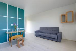 a living room with a couch and a table at Частный сектор in Bosteri