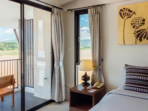 Postel nebo postele na pokoji v ubytování Fortune Riverview Hotel Chiang Khong
