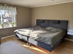 a bedroom with a bed in a room with a window at Villa Borgholm - Öland in Borgholm