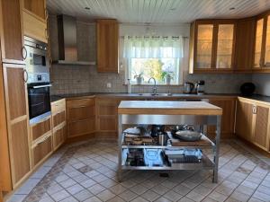 a kitchen with a sink and a stove in it at Villa Borgholm - Öland in Borgholm