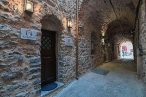 a stone building with a door in a hallway at Livadi Mesta Apartments in Mesta