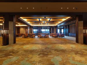 a room filled with lots of chairs and tables at Kitakobushi Shiretoko Hotel & Resort in Shari