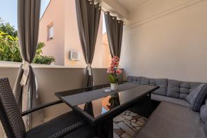 a living room with a table and a couch at Floyd in Bibinje