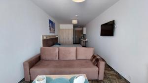 a living room with a couch and a bed at Apartament Sand Welle in Grzybowo