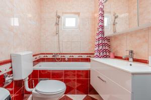 a bathroom with a toilet and a tub and a sink at Floyd in Bibinje +37 photos