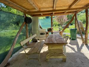 a patio with a table and chairs and a stove at Dream House Šeha in Bihać +30 photos