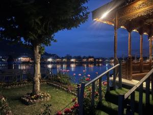 a view of the water at night with a gazebo at The Badyari Houseboats Group in Srinagar +7 photos