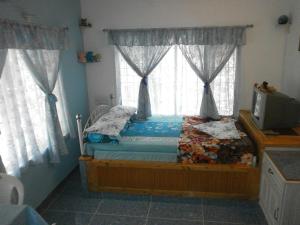 Postel nebo postele na pokoji v ubytování Aldos Ark Home Stay