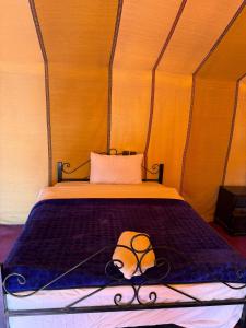 A bed or beds in a room at Luxury Merzouga Desert Camp