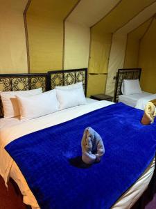 A bed or beds in a room at Luxury Merzouga Desert Camp