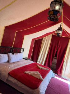 A bed or beds in a room at Luxury Merzouga Desert Camp