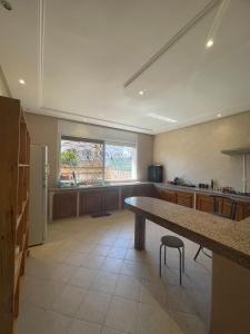 a large kitchen with a large table and a window at Villa à louer nouaceur in Nouaseur