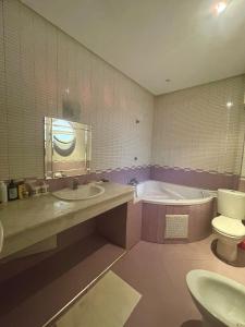 a bathroom with a sink and a tub and a toilet at Villa à louer nouaceur 3 chambres in Nouaseur +19 photos