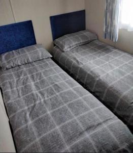 two beds sitting next to each other in a bedroom at Lorna's Hideaway! in Selsey
