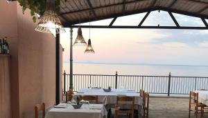 a dining room with a view of the ocean at Donna Pulina Holidays in Pollina