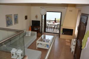 a living room with a couch and a table at Dream House in Nea Roda