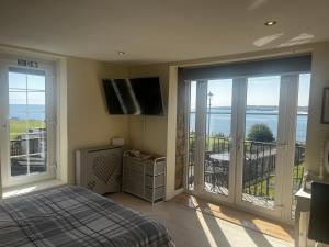 a bedroom with a bed and a view of the ocean at The View in Tynemouth