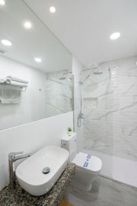 a white bathroom with a toilet and a shower at ABLANCAS - La Restinga in La Restinga