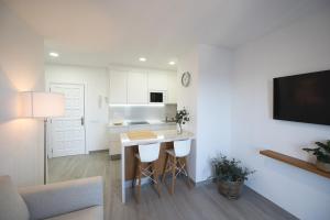 a kitchen and living room with a table and chairs at ABLANCAS - La Restinga in La Restinga