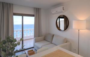 a living room with a couch and a large window at ABLANCAS - La Restinga in La Restinga