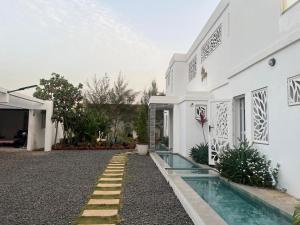 a white house with a swimming pool in front of it at Villa Bamby in Ponto