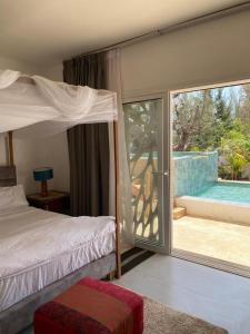 a bedroom with a bed and a view of a pool at Villa Bamby in Ponto