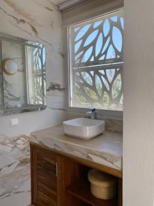 a bathroom with a sink and a window at Villa Bamby in Ponto +19 photos