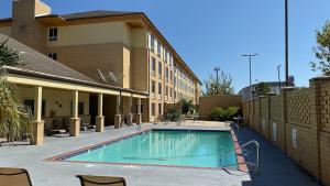 a swimming pool in front of a building at Trident Inn & Suites New Orleans in New Orleans