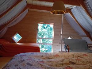 a bedroom with a bed and a window at Merevaatega puhkemaja Pädaste lahe ääres in Pädaste +9 photos