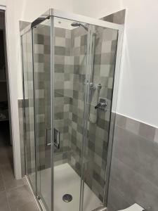 a shower with a glass door in a bathroom at Little House On The Sea in Acireale +9 photos