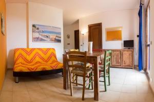 a living room with a dining room table and chairs at Residence Vistamare La Fonte in Nisporto
