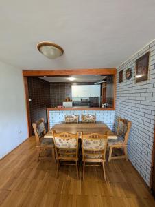 a dining room with a wooden table and chairs at NiceOneLakeView in Plužine +16 photos