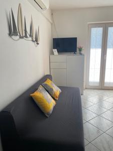 a bedroom with a black bed with two pillows on it at Studio Lokvica in Omišalj