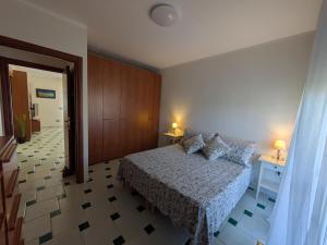 a bedroom with a bed and two tables and two lamps at Orchidea Borghese in Nettuno