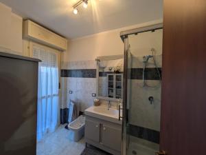 a bathroom with a shower and a sink and a toilet at Orchidea Borghese in Nettuno +22 photos