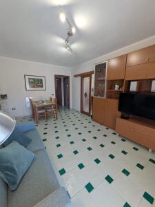 a living room with a couch and a table at Orchidea Borghese in Nettuno