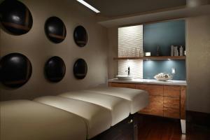 a bedroom with a large bed and a sink at Marriott Montreal Airport In-Terminal Hotel in Dorval