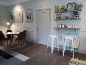 a dining room with a table and two stools at Kileenlea Cottage in Killadoon