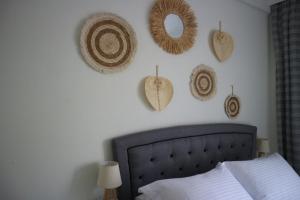 a bedroom with a bed and some hats on the wall at Grandma Mary's Apartment Nea Playia in Nea Plagia