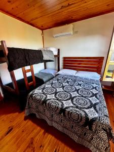 a bedroom with a bed in a room at Complejo de cabañas Tikuna in Concepción del Uruguay +31 photos