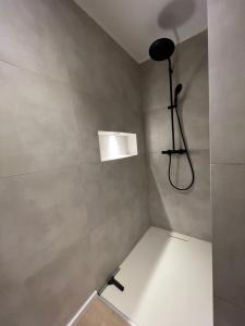 a bathroom with a shower with a light on the wall at Bungalow Modern Living in Memmingen +8 photos