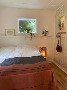 a bedroom with a bed and a window at 5 min from the water's edge in Strøby