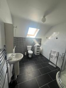 a bathroom with a sink and a toilet at Fabulous 4 Bedroom House, Gateway to Connemara in Galway